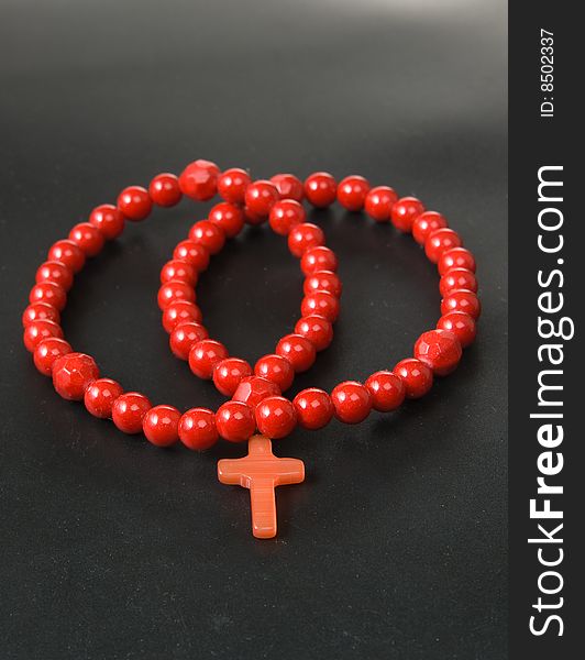 Red coral necklace, black background