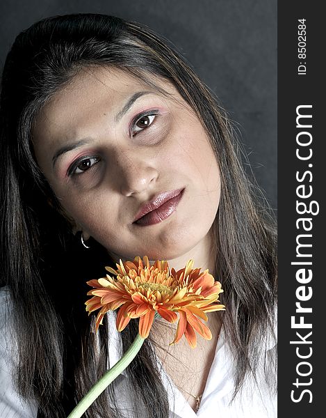 Girl with flower in studio.