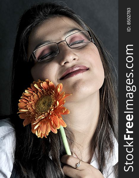 Girl with flower in studio.