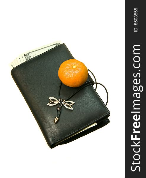 Leather wallet cash for women, with some barely visible banknotes inside, close-up isolated on white background, with mandarine on it. Leather wallet cash for women, with some barely visible banknotes inside, close-up isolated on white background, with mandarine on it.