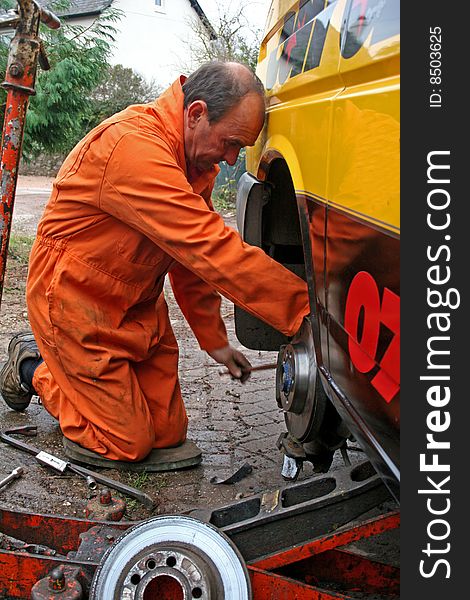 Engineer changing brake disc on van