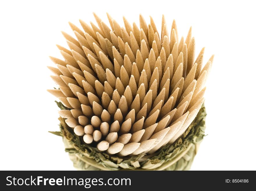 Bamboo toothpicks in a wum basket isolated on a white background