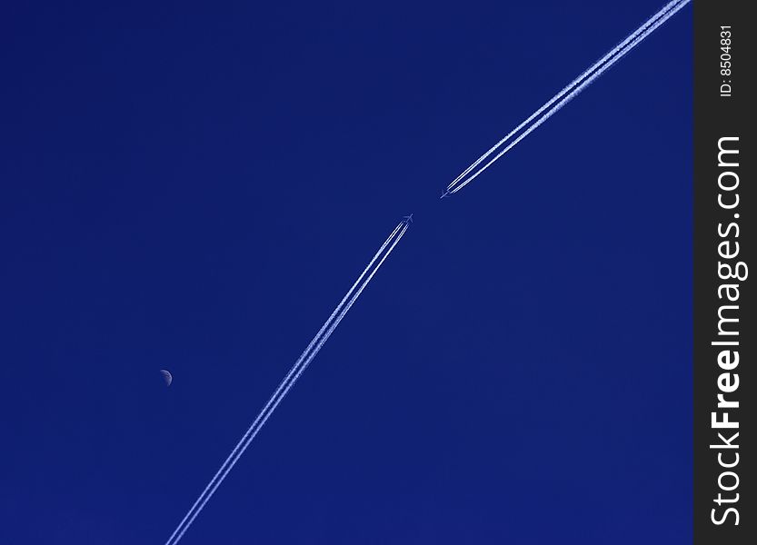 Aeroplane with track against deep blue sky