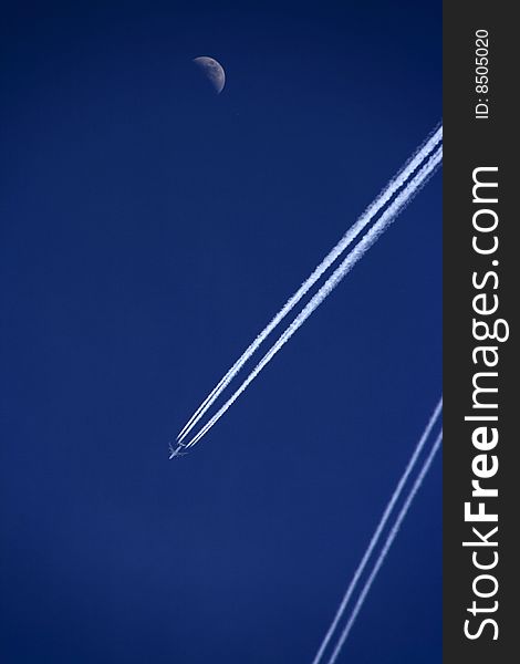 Aeroplane with track against deep blue sky