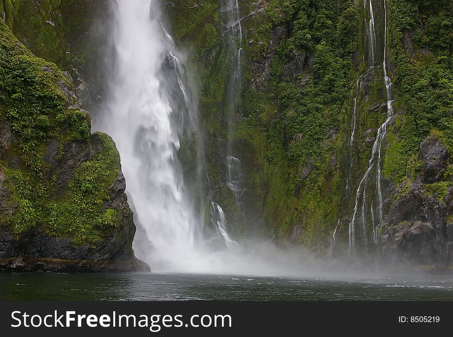 Waterfall in milford sound, new zealand