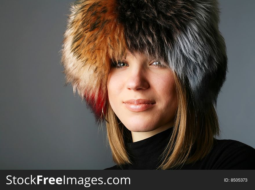 Portrait of a beautiful woman in a fur hat