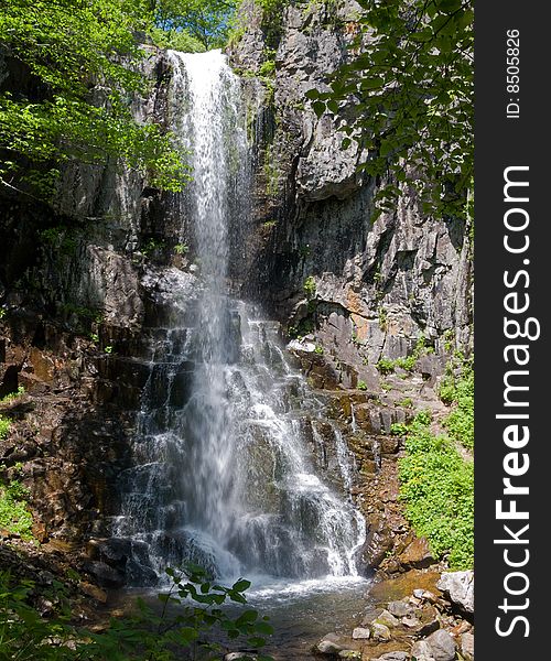 A waterfall among taiga. Russian Far East, waterfall Elamovsky. A waterfall among taiga. Russian Far East, waterfall Elamovsky.