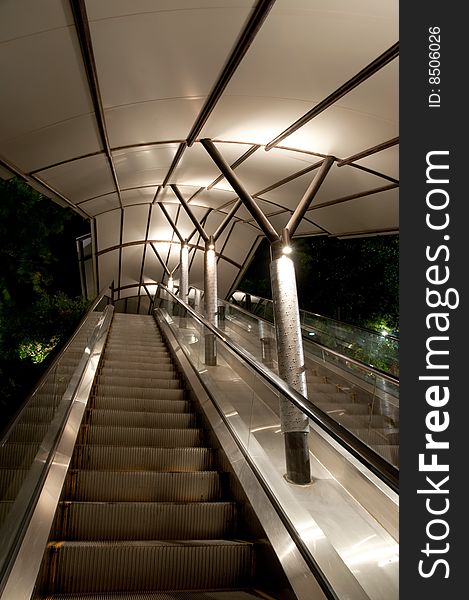Well lit sheltered escalator at night
