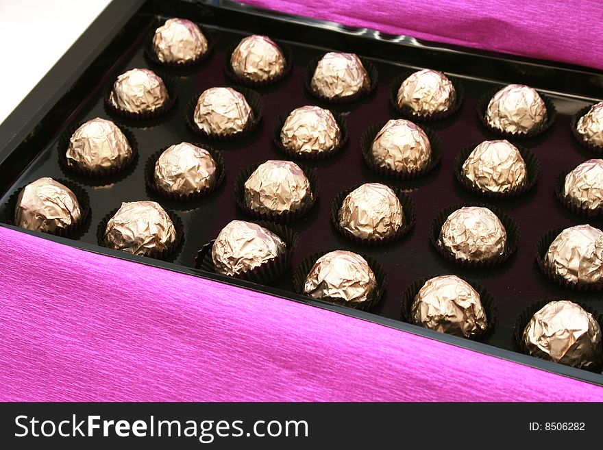 Beautiful candy in box - golden colors - concept holidays and gift