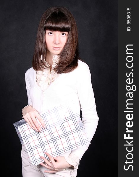 Girl with folder standing in studio