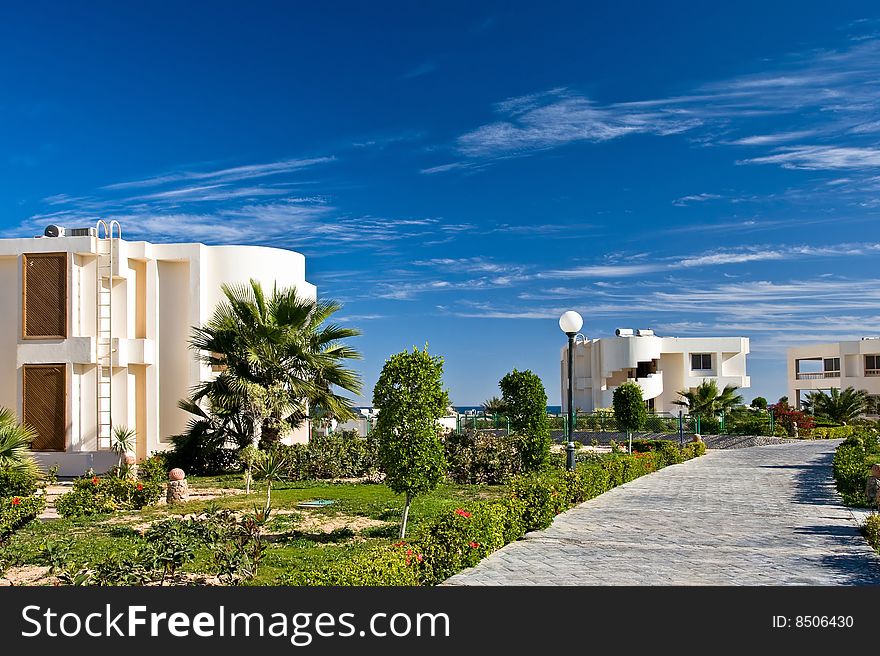 Resort hotel with bungalow. Bright blue sky. Resort hotel with bungalow. Bright blue sky