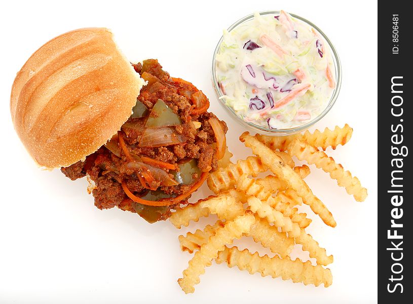 Homemade ground sirloin sloppy Joe with large chunks of vegetables on white with crinkle fries and coleslaw. Homemade ground sirloin sloppy Joe with large chunks of vegetables on white with crinkle fries and coleslaw.
