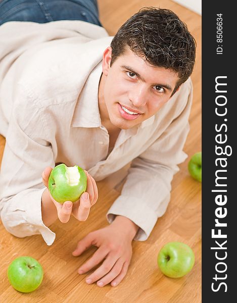 Young man eating green and healthy apples. Young man eating green and healthy apples