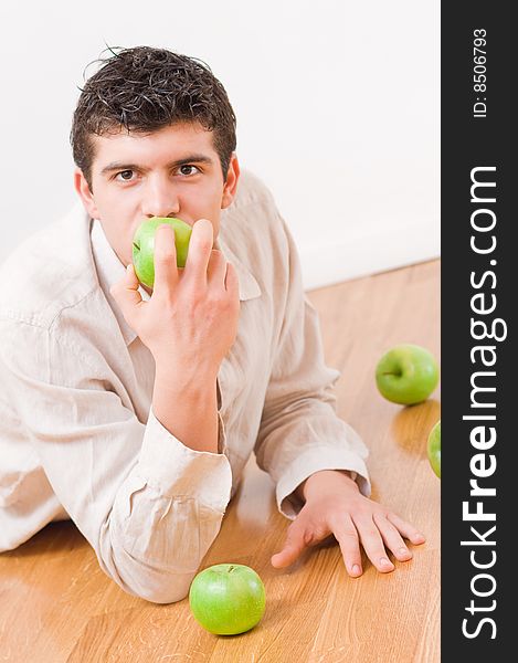 Young man eating green and healthy apples. Young man eating green and healthy apples