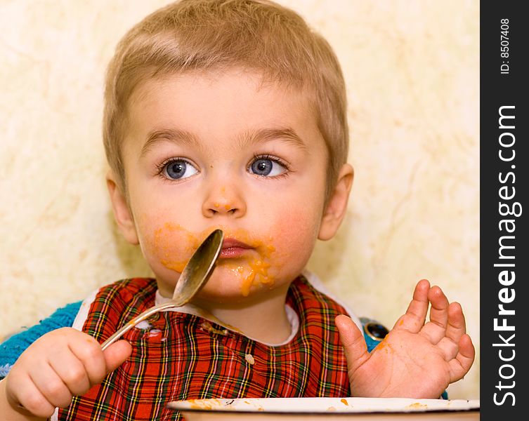 Cute small boy eating squash