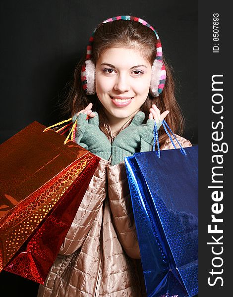 Portrait of the girl with color packages in hands. Portrait of the girl with color packages in hands.