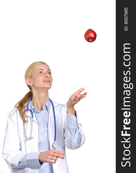 Female medical student tossing up an apple