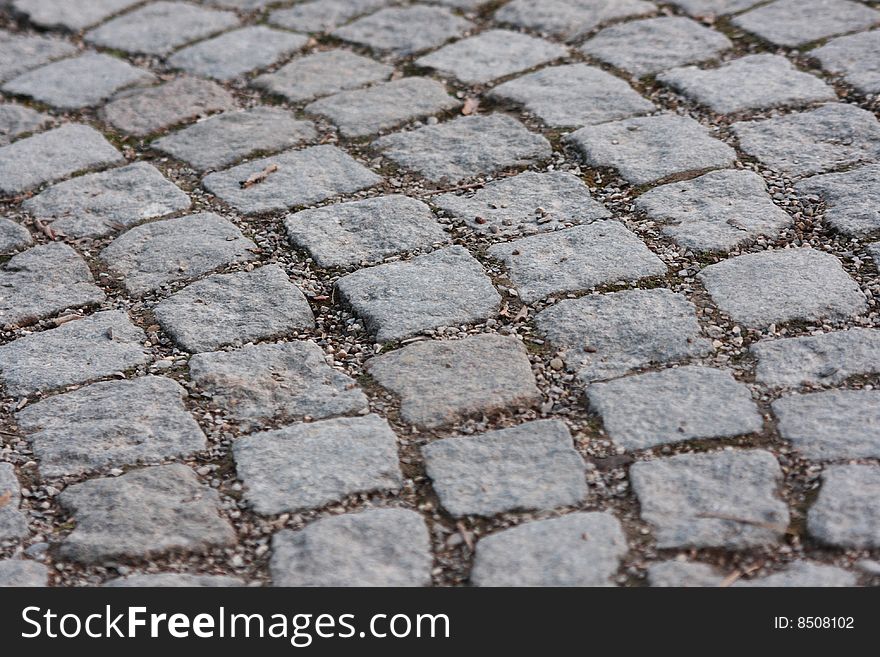 A circular cobbled pathway close up