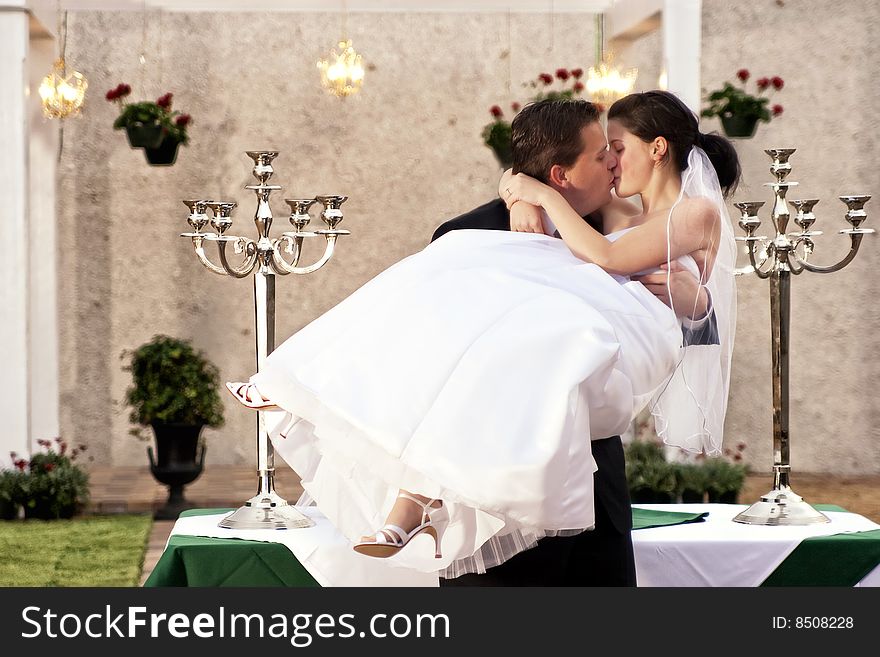 Groom Holding Bride Kissing