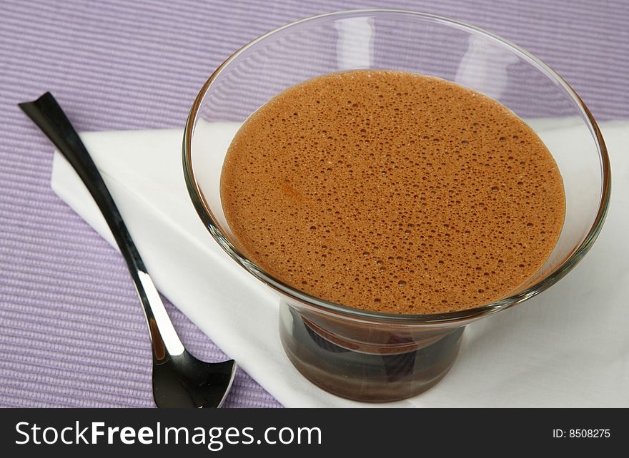 Chocolate dessert in cup on table