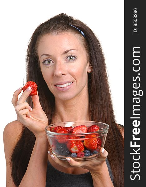 Fitness woman eating fresh fruit isolated on white