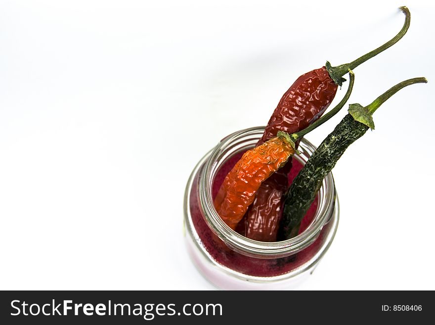 Dried chilies in a jar  isolated on  a white background. Dried chilies in a jar  isolated on  a white background.