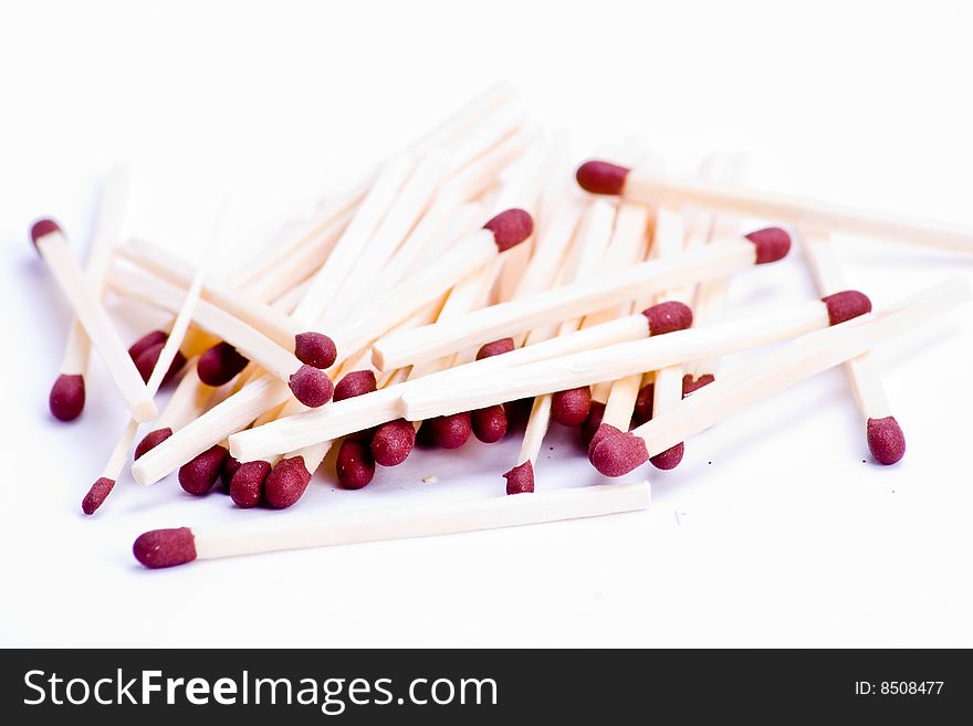 A pile of matches with red tips over white
