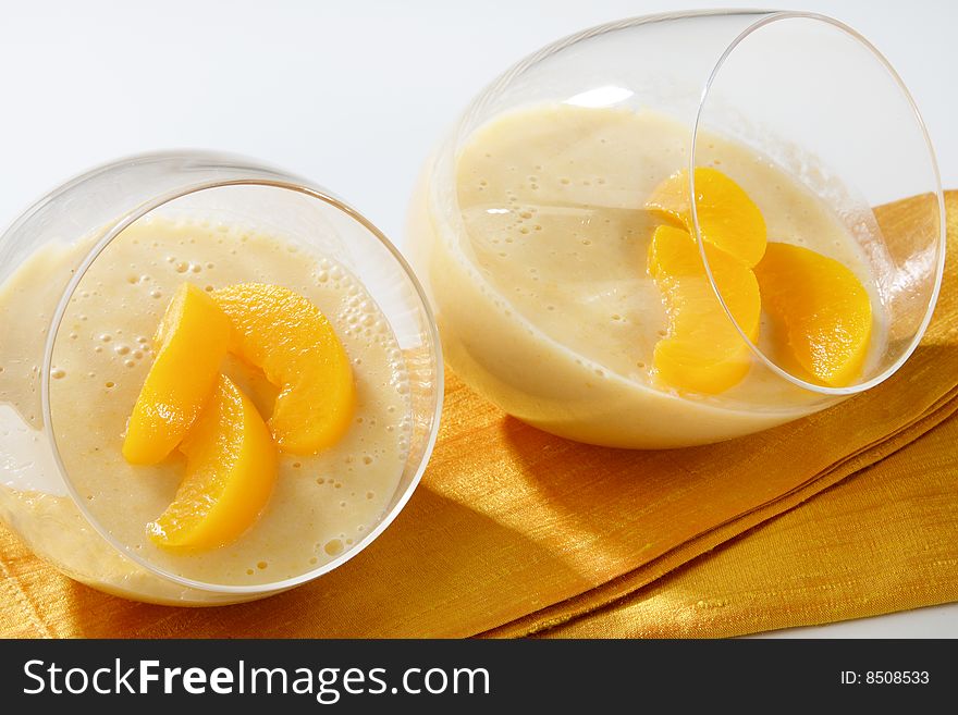 Yogurt with peach fruit in glass