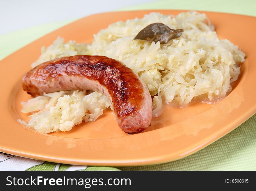 Cabbage with sausage on plate
