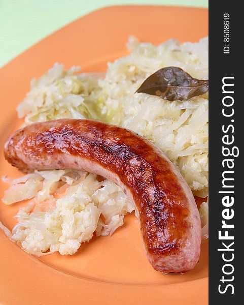 Cabbage with sausage on plate