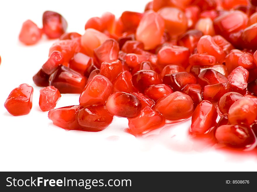 Bright and fresh Pomegranate seeds on white