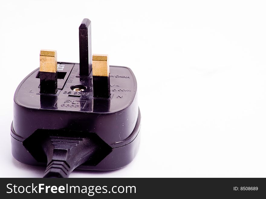 A black electrical plug isolated over white. A black electrical plug isolated over white