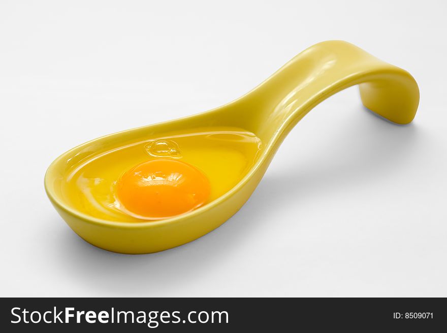 The spoon with egg in it