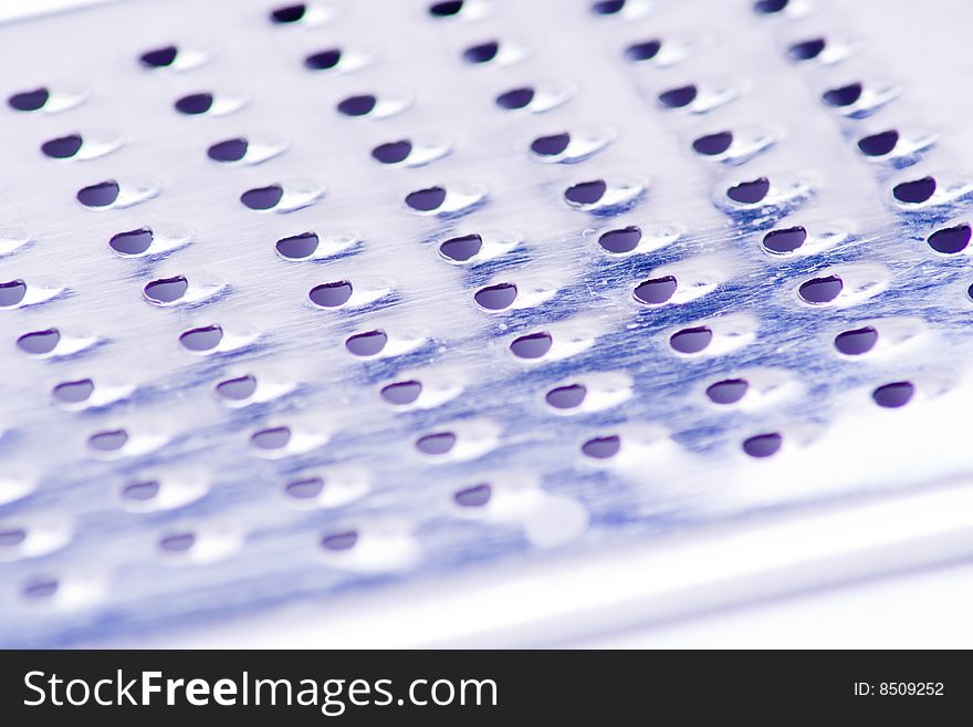 Macro of texture of silver kitchen grater. Macro of texture of silver kitchen grater