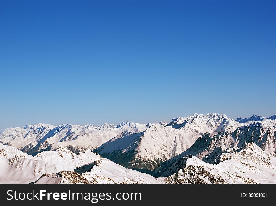 Landscape of snow-capped mountain peaks in the Alps, and a lot of air cleanliness