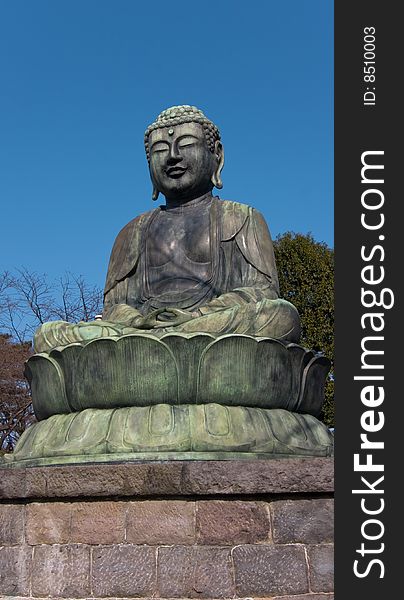 View on a sitting Buddha statue in Ikebukuro, Tokyo, Japan