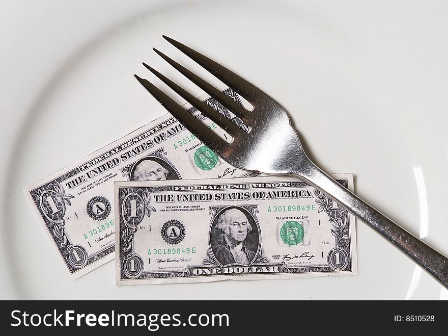 Shrunken dollars on white plate with a fork. Shrunken dollars on white plate with a fork.