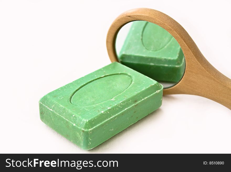 Green Soap reflecting on a mirror on white background