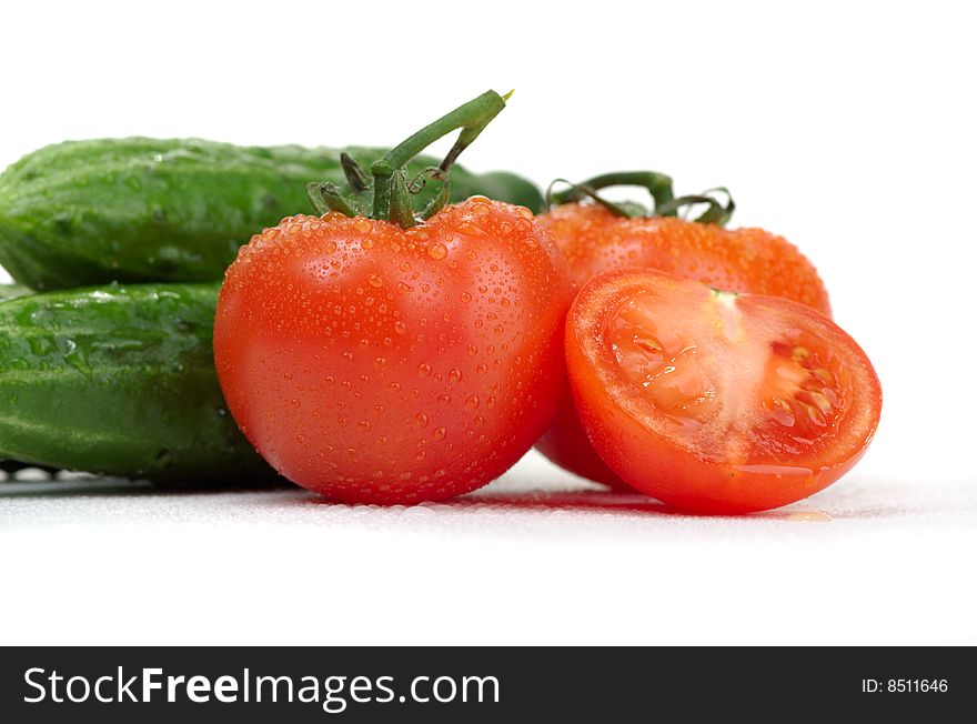 Fresh cucumbers and tomatoes on a white background