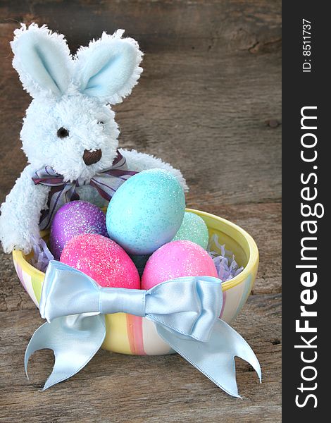 Stuffed Easter bunny with Easter eggs and a pretty blue bow. Stuffed Easter bunny with Easter eggs and a pretty blue bow.