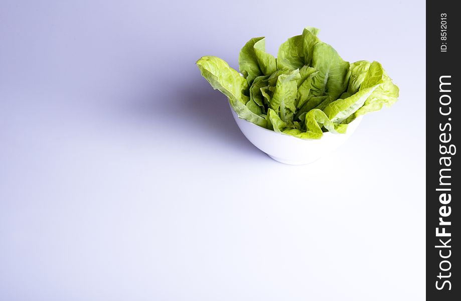 Green salad in white bowl