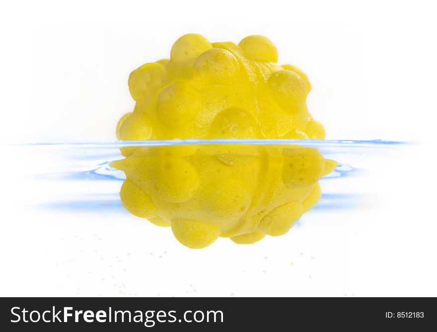 A yellow ball was dropped in water.