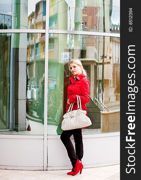Beautiful young woman in red coat and boots. Beautiful young woman in red coat and boots