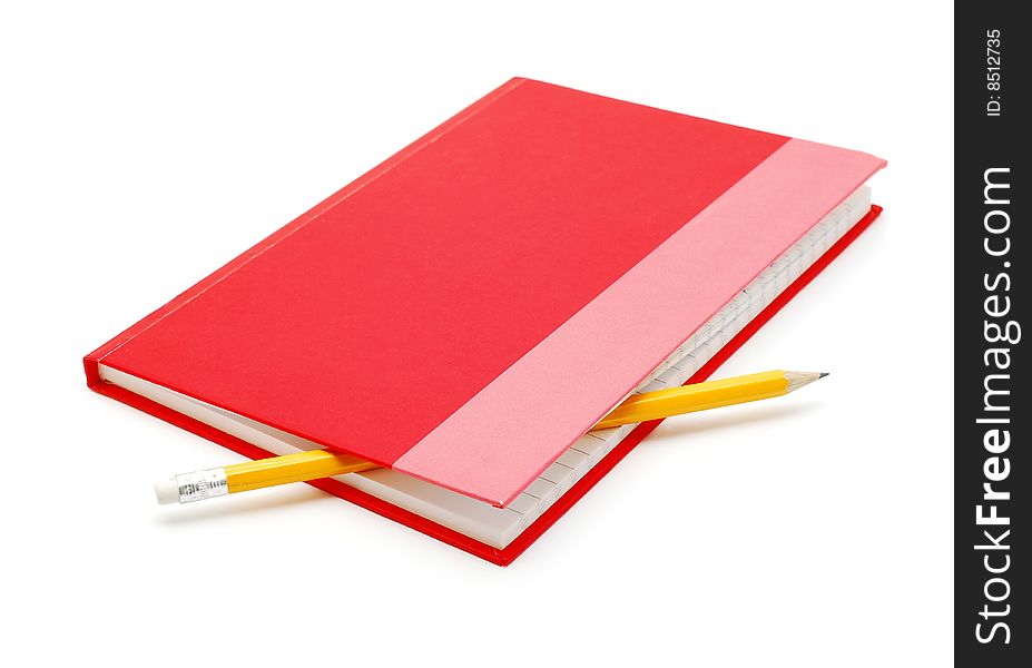 Red notebook with pencil over white background