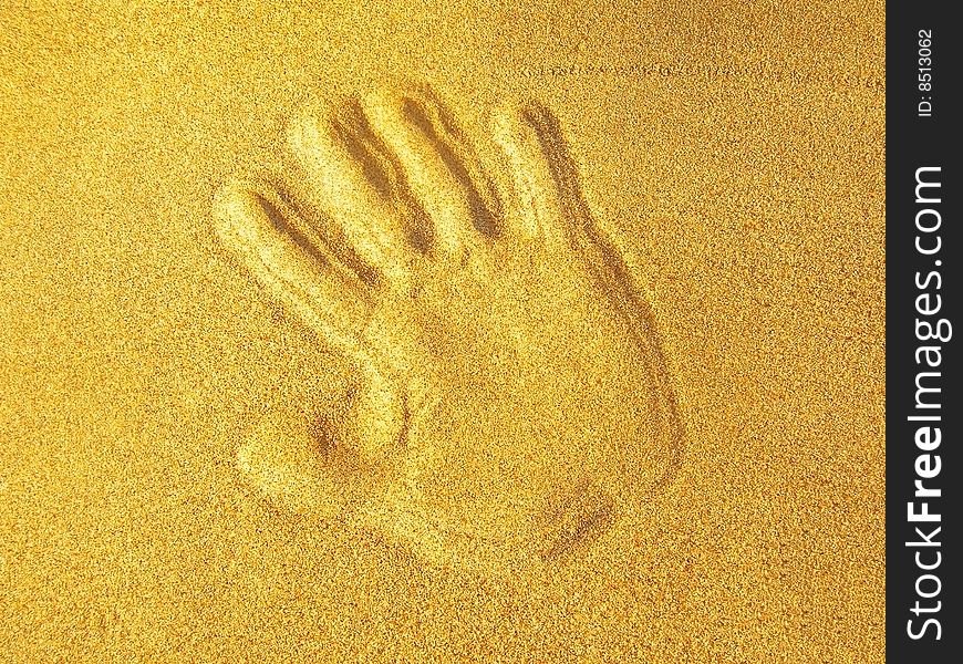 Hand print on beach sand