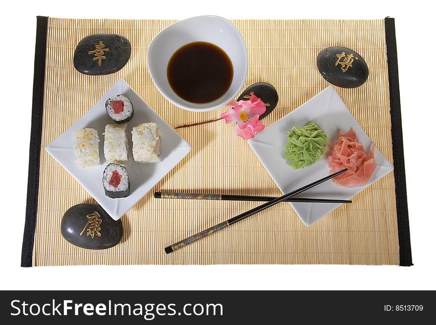 Sushi plate with chopsticks and pink flower