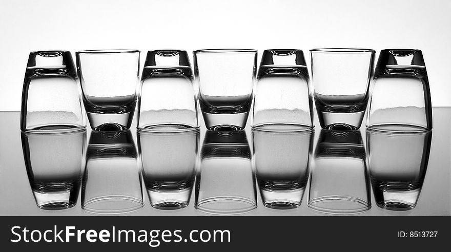 Set of the liquor-glasses on glass surface