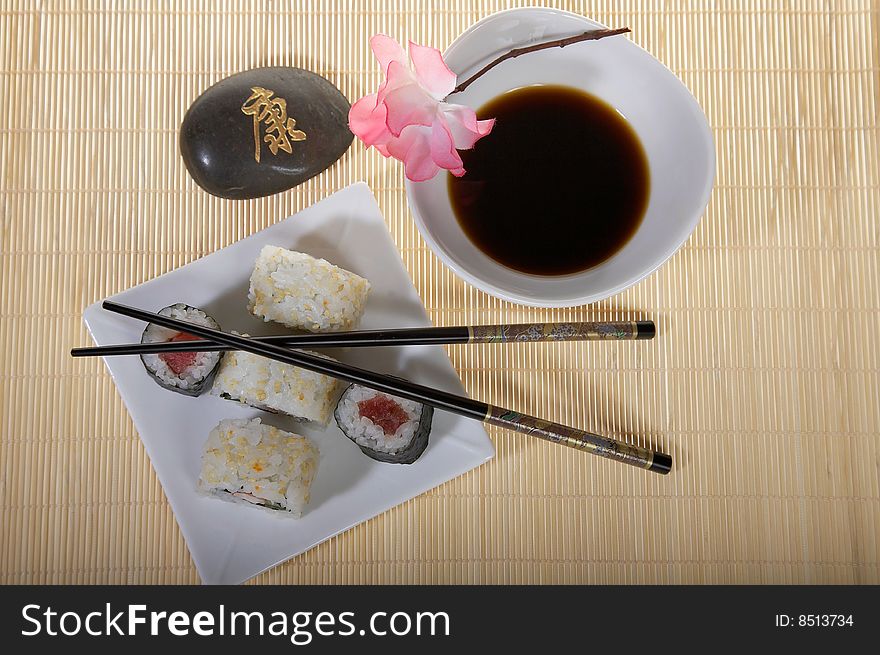 Sushi plate with chopsticks and flower