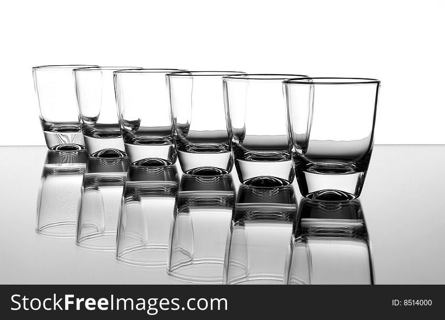 Set of the liquor-glasses on glass surface