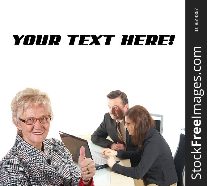 Businesswoman showing tumb up sign in office environment. Three people with focus on mature woman in front. Isolated over white. Businesswoman showing tumb up sign in office environment. Three people with focus on mature woman in front. Isolated over white.